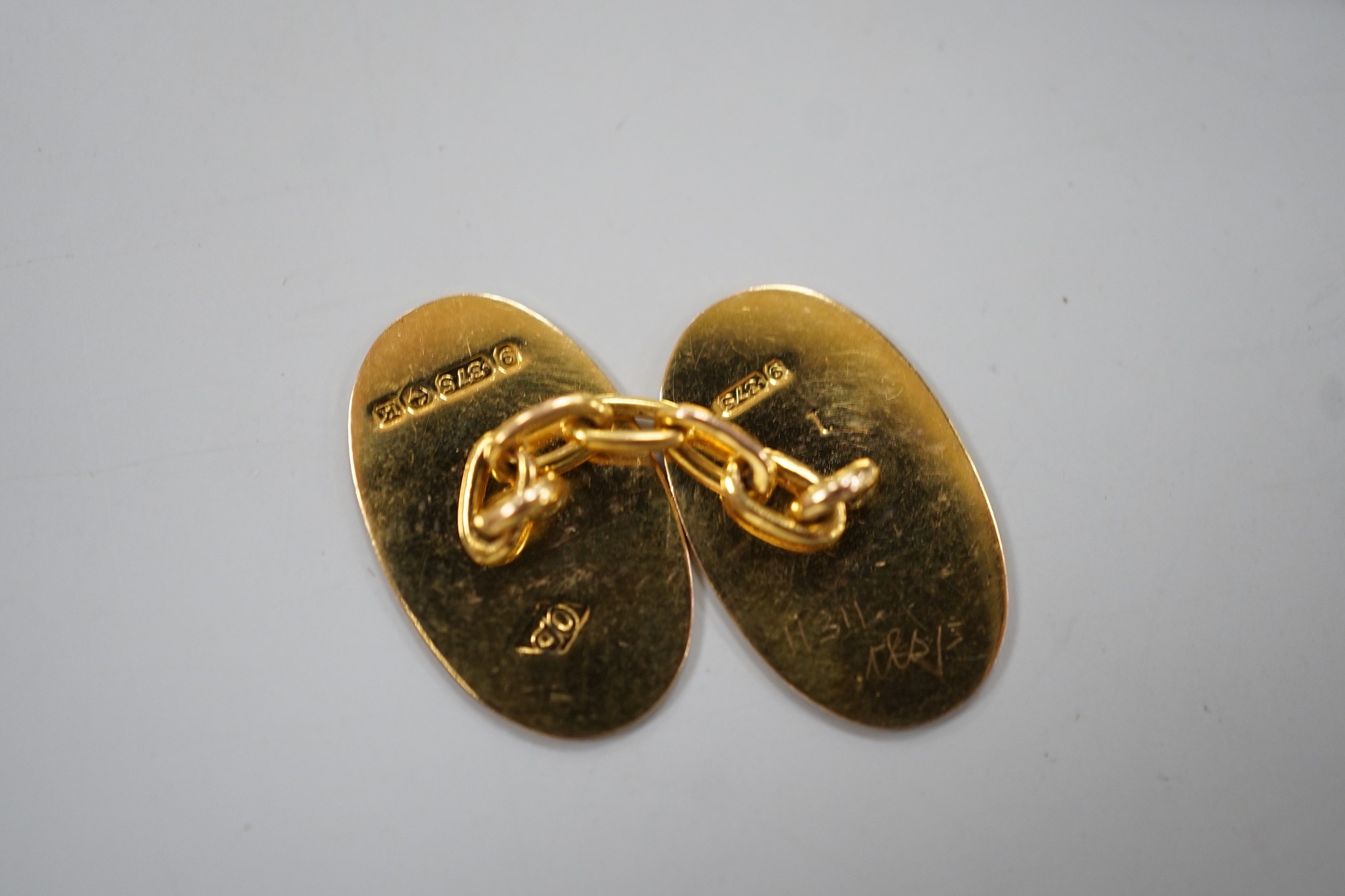 A pair of George V 9ct. gold oval cuff links, with engraved monograms, cased, 4.3 grams.